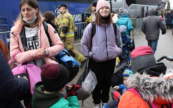 Ukrainians having arrived at a transit center in the border city of border city of Korczowa, Poland, wait for buses that will take them elsewhere to Poland or other countries in Europe. (GSR photo/Chris Herlinger)