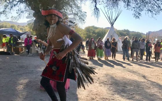 Waya Brown, who is Apache and Pomo, dances in a circle at Oak Flat campground on Saturday, Feb. 27, 2021, near Superior, Arizona. (RNS/Alejandra Molina)