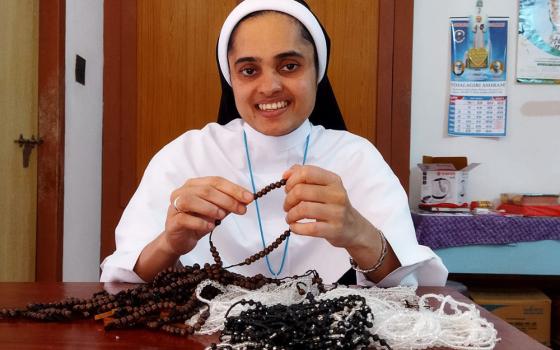 Sr. Rini Rose of the Sisters of the Adoration of the Blessed Sacrament makes rosaries at her community's convent in Ambalavayal, Kerala, India. (Courtesy of the Sisters of the Adoration of the Blessed Sacrament)