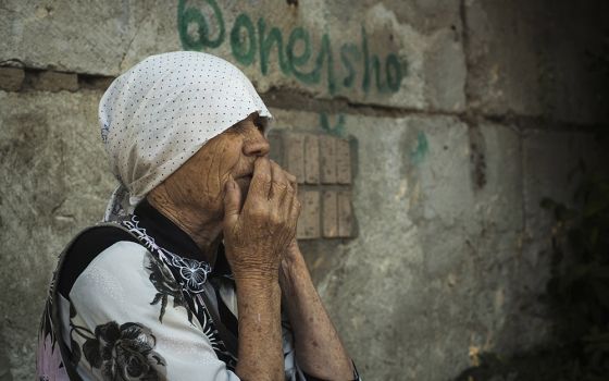 An elderly Ukrainian woman looks on after Russian shelling in Mykolaiv, Ukraine, June 29. (AP/George Ivanchenko)