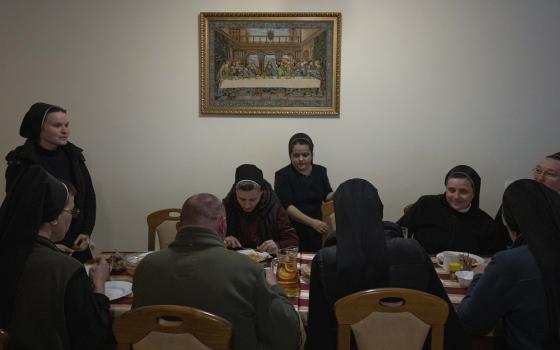 Nuns eat dinner April 6 at the Hoshiv Women Monastery, where they have been taking in internally displaced families fleeing the war in Ivano-Frankivsk region, western Ukraine. 