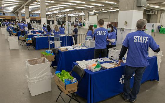 SCL Health associates prepare to check in patients at A Feb. 6 mass-vaccination clinic at the National Western Complex, a convention space in Denver. In 10 hours, 5,000 people were inoculated.