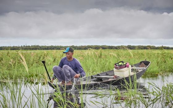 Rodrigo Oliveira checks his fishing net in the Ituqui River near his home in the Quilombo Bom Jardim, near Santarem, Brazil. For many traditional peoples, activities like hunting and fishing are closely tied to spiritual beliefs. (CNS Photo/Paul Jeffrey)