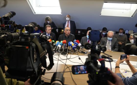 Cardenal Juan Jose Omella, center, speaks during a press conference in Madrid, Spain, Tuesday, Feb. 22, 2022. (AP Photo/Paul White)