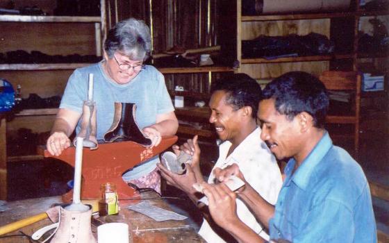 Sr. Susan Gubbins makes a prosthesis with men during her ministry in East Timor. (Courtesy of Susan Gubbins)