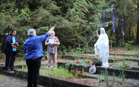 Some of the Benedictine Sisters of St. Placid Priory in Lacey, Washington, pray at a distance during an outdoor May crowning. (Courtesy of Benedictine Sisters of St. Placid Priory)