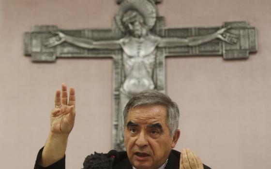 Cardinal Angelo Becciu talks to journalists during a press conference in Rome, Sept. 25, 2020. (AP Photo/Gregorio Borgia, File)