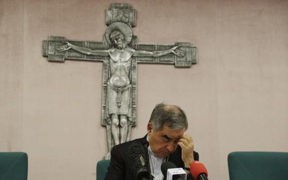 Cardinal Angelo Becciu talks to journalists during a press conference in Rome, on Sept. 25, 2020. (AP Photo/Gregorio Borgia, File)