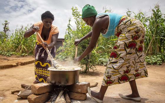 Volunteers for Catholic Relief Services in Zambia preparing a demonstration meal, stressing the need to use local crops and ingredients in meals. (Catholic Relief Services/Dooshima Tsee)