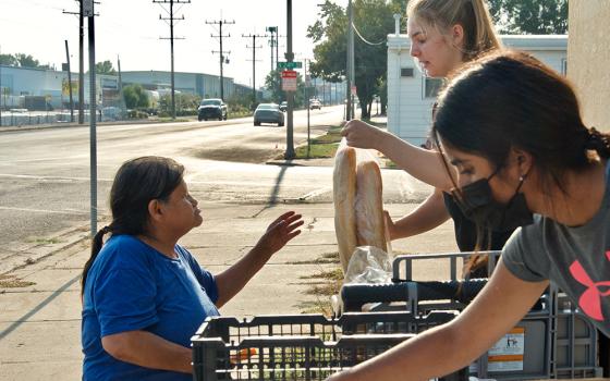 Volunteers hand out food during the twice-weekly food pantry at Ministry on the Margins in Bismarck, North Dakota. (GSR photo/Dan Stockman) 