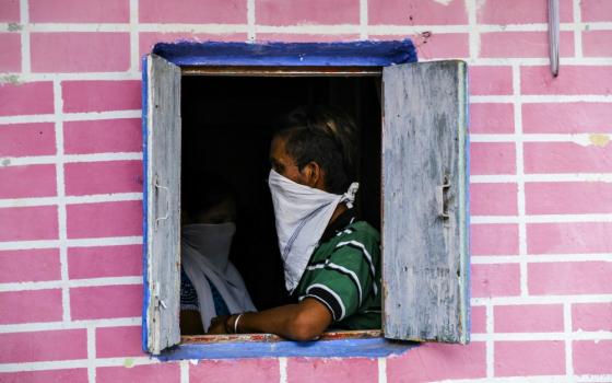 A man covers his face with a handkerchief for coronavirus protection in Mumbai, India, June 17. (Dreamstime/Srinivas Akella Ramalingaswami)