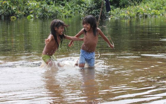 Two Urarina Indigenous girls play in the Urituyacu River in northeastern Peru. (Photo/Barbara Fraser)