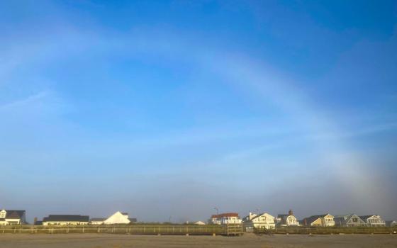 White arc in blue sky