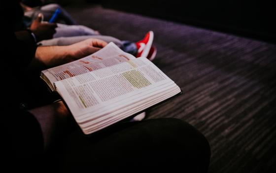 Woman reads a highlighted Bible