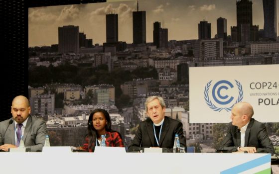 Msgr. Bruno-Marie Duffé, second from right, speaks at a press conference Dec. 12 in Katowice, Poland. With him are, from left, Joseph Sapati Moeono-Kolio, Mercy Chirambo and Neil Thorns. (NCR photo/Brian Roewe)