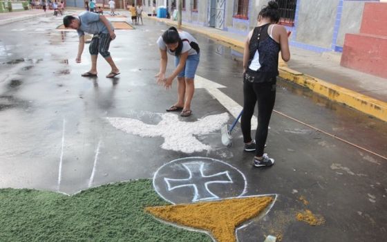 Young people in the Peruvian town of Nauta prepare street paintings made of colored sawdust in preparation for Holy Week processions. (Barbara Fraser)