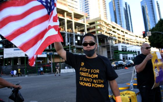 A fan wears a T-shirt supporting Hong Kong and holds a U.S. flag before an NBA game between the Los Angeles Lakers and the LA Clippers in that city Oct. 22. (Newscom/USA Today Sports/Kirby Lee)