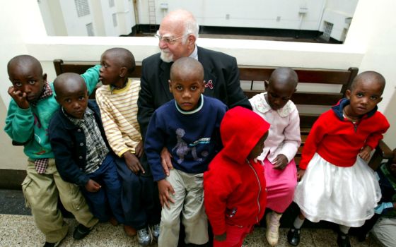 Jesuit Fr. Angelo D'Agostino, founder of Nyumbani children's home for HIV/AIDS orphans sits outside a courtroom in Nairobi, Kenya, in January 2004. (Newscom/Reuters/Antony Njuguna)