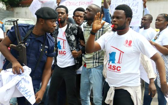 Police officers attempt to disperse members of the Civil Society Action Collective chanting slogans in a demonstration calling for free and fair elections Sept. 19 in Kinshasa, Democratic Republic of Congo. (Newscom/Reuters/Kenny Katombe)