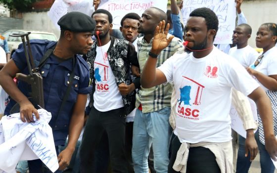 Police officers attempt to disperse members of the Civil Society Action Collective chanting slogans in a demonstration calling for free and fair elections Sept. 19 in Kinshasa, Democratic Republic of Congo. (Newscom/Reuters/Kenny Katombe)