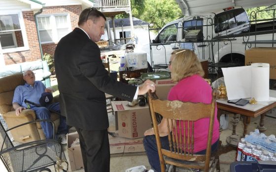 Bishop J. Mark Spalding of Nashville, Tennessee., talks with James and Patsy Bradley of Waverly, Tennessee, Aug. 24. The parishioners of St. Patrick Catholic Church in McEwan, Tennessee, said their home was destroyed by the Aug, 21 flooding. (CNS photo/Ka