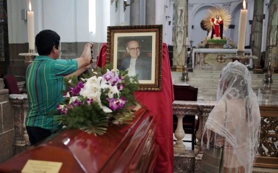 People stand around the casket of Auxiliary Bishop Juan Gerardi at the cathedral in Guatemala City April 25, 2013, in observance of the 15th anniversary of his murder. (CNS/Jorge Dan Lopez, Reuters)