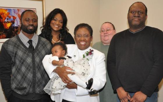 Dominican Sr. Patricia Dual, holding a grandchild, with her family members celebrating her final profession of vows. (Provided photo)