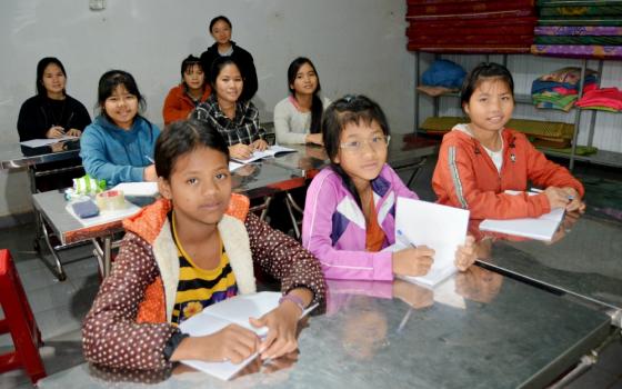 Mary Ben (wearing glasses) and her friends study math in advance of the coming school year. (Joachim Pham)