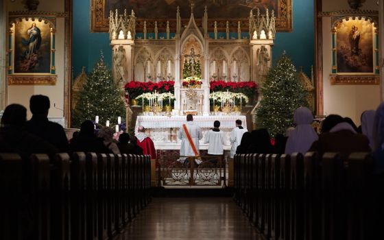 Worshipers kneel in prayer during eucharistic adoration following a Mass marking the feast of the Holy Innocents Dec. 28, 2020, at the Church of the Holy Innocents in New York City. (CNS/Gregory A. Shemitz)