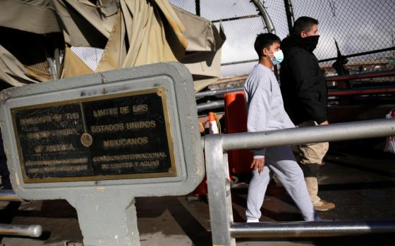 A migrant is deported from the U.S., and into Ciudad Juarez, Mexico, through the Paso del Norte international border bridge Jan. 26. (CNS/Reuters/Jose Luis Gonzalez)