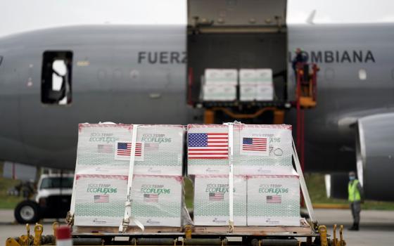 U.S. flags are taped on a shipment of Johnson & Johnson COVID-19 vaccines in Bogota, Colombia, July 1. (CNS photo/Nathalia Angarita, Reuters)