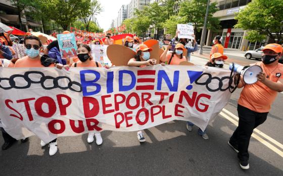 Immigration advocates hold a demonstration near the White House in Washington April 28 calling on President Joe Biden to secure a path to citizenship for immigrants living in the country illegally. (CNS/Reuters/Kevin Lamarque)