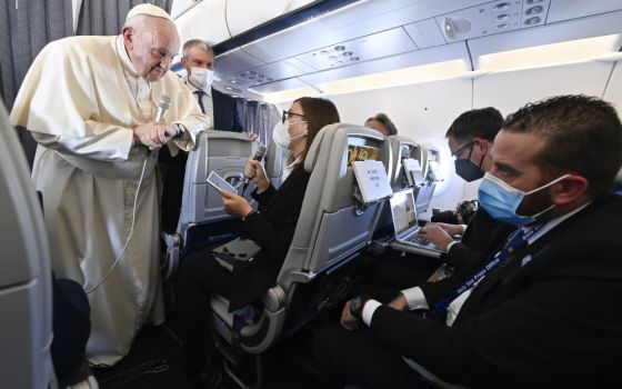 Pope Francis answers questions from journalists aboard his flight from Athens, Greece, to Rome Dec. 6, 2021. (CNS/Vatican Media)