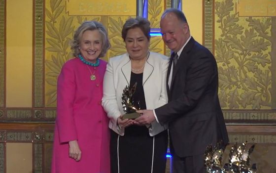 Patricia Espinosa, executive secretary of the United Nations Framework Convention on Climate Change, receives an award from Georgetown Institute for Women, Peace and Security. Also pictured are Hillary Clinton and Georgetown president John DeGioia.