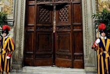 Swiss Guards stand in front of the doors to the Vatican's Sistine Chapel as cardinals begin the conclave to elect a successor to Pope Benedict XVI in March 2013. (CNS/L'Osservatore Romano via Reuters)