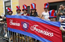 People hold a banner thanking Pope Francis along the parade route for the pope in Trujillo, Peru, Jan. 20. (CNS/Paul Haring)