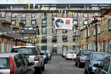 A banner with an image of Pope Francis overlooks a street lined with cars Aug. 13 in Dublin ahead of the World Meeting of Families. (CNS/Reuters/Clodagh Kilcoyne) 