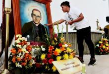 A young man touches a picture of St. Óscar Romero during an Oct. 13 Mass at the Metropolitan Cathedral in Managua, Nicaragua. The Mass was celebrated for Romero and six other new saints canonized Oct. 14 at the Vatican. (CNS/Reuters/Oswaldo Rivas)