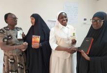 A Catholic woman and nun exchange holy books with Muslim women leaders Dec. 13, 2019, in Garissa, Kenya. (CNS/Courtesy of Fr. Nicholas Mutua)