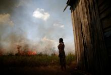 Miraceli de Oliveira reacts as fire approaches her house in an area of the Amazon rainforest near Porto Velho, Brazil, Aug. 16. (CNS/Reuters/Ueslei Marcelino)