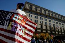 A man in Washington waves an American flag with the words "Biden Harris" near the White House Nov. 8, the day after the news media called the presidential election for Democrat Joe Biden. (CNS/Reuters/Erin Scott)