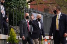 President Joe Biden waves as he departs Holy Trinity Catholic Church April 10 in Washington. (CNS/Erin Scott, Reuters)