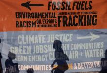 Environmental activists protest outside the White House in Washington, D.C., June 30, demanding that President Joe Biden stop fossil fuel projects and put climate justice at the heart of his infrastructure plans. (CNS photo/Evelyn Hockstein, Reuters)