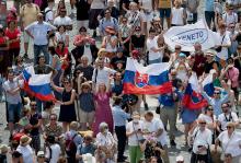 Pilgrims holding the Slovak flag cheer in St. Peter's Square at the Vatican July 4, 2021, as Pope Francis announces he will visit their country Sept. 12-15. (CNS/Vatican Media)