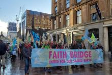 A group of interfaith climate pilgrims join hundreds of people processing into central Glasgow, Scotland, Oct. 30, ahead of the start COP26, the United Nations climate change conference. (EarthBeat photo/Brian Roewe)