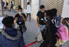 Volunteers assist migrants outside Holy Cross Catholic Church next to the United Nations buffer zone in Nicosia, Cyprus, Nov. 24. (CNS/Reuters/Yiannis Kourtoglou)