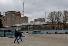 People walk outside the Zaporizhzhia Nuclear Power Plant in the course of Russia-Ukraine conflict outside Enerhodar in the Zaporizhzhia region, Russian-controlled Ukraine, March 29, 2023. (OSV News/Reuters/Alexander Ermochenko)