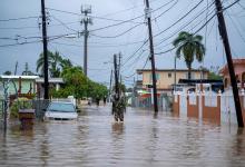 A member of the Puerto Rico National Guard wades through water Sept. 19, 2022, in search for people to be rescued from flooded streets in the aftermath of Hurricane Fiona in Salinas, Puerto Rico. (CNS/Ricardo Arduengo)