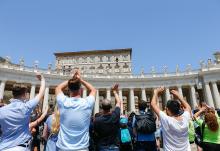 Visitors applaud and greet Pope Francis after praying the Angelus in St. Peter's Square at the Vatican July 9. (CNS/Lola Gomez)