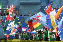 Pope Francis, on stage, looks over the procession of flags from the all the countries represented by young people participating in World Youth Day during the event's welcome ceremony at Eduardo VII Park in Lisbon, Portugal, Aug. 3. (CNS/Vatican Media)